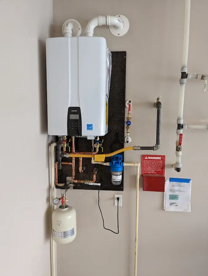 Professional plumber installing copper piping in a Parkesburg home